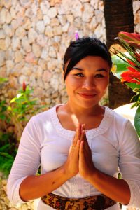 Balinese woman greeting with hands together